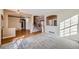 Inviting entryway featuring plush carpet, hardwood flooring, neutral walls and staircase to the second floor at 3938 Lazy K Dr, Castle Rock, CO 80104