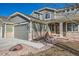 Exterior front view of home shows the stone accents, two-car garage, and walkway to the front door at 3938 Lazy K Dr, Castle Rock, CO 80104