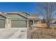 Charming two-story home with a well-maintained lawn, a two-car garage, and stone accents at 3938 Lazy K Dr, Castle Rock, CO 80104