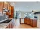 Beautiful kitchen featuring hardwood floors, wood cabinets, granite counters, stainless steel appliances, and center island at 3938 Lazy K Dr, Castle Rock, CO 80104