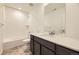 Bathroom featuring shower-tub combo, vanity with marble countertops, and neutral walls at 7307 Waterleaf Trl, Littleton, CO 80125