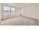 Spacious bedroom with carpeted flooring and large windows offering natural light at 7307 Waterleaf Trl, Littleton, CO 80125