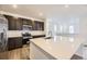 Modern kitchen with dark cabinets, stainless steel appliances, and a spacious white quartz island at 7307 Waterleaf Trl, Littleton, CO 80125