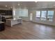 Bright, open-concept living area with hardwood floors and an adjacent kitchen at 7307 Waterleaf Trl, Littleton, CO 80125