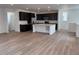 Open-concept floorplan featuring hardwood flooring, a kitchen, and recessed lighting at 7307 Waterleaf Trl, Littleton, CO 80125