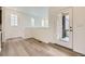 Bright living room with stairs and entrance view, showcasing wood floors and natural light at 7307 Waterleaf Trl, Littleton, CO 80125