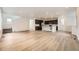 Open-concept living area features wood floors and recessed lighting, seamlessly flowing into the kitchen at 7307 Waterleaf Trl, Littleton, CO 80125
