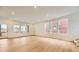 Bright living room featuring hardwood floors and a large window showing outdoor views at 7307 Waterleaf Trl, Littleton, CO 80125