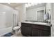 Bright bathroom featuring double sinks, modern fixtures, shower and tub combination at 19221 E 65Th Ave, Denver, CO 80249