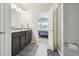 Bathroom featuring double sink vanity with granite countertop, walk-in shower, and tile floor at 19221 E 65Th Ave, Denver, CO 80249