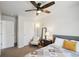 Cozy bedroom with ceiling fan, closet and soothing neutral tones and patterned quilt at 19221 E 65Th Ave, Denver, CO 80249