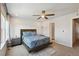 Spacious bedroom featuring ceiling fan, plush carpet, and comfortable bed with stylish bedding at 19221 E 65Th Ave, Denver, CO 80249