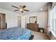 Bright bedroom featuring ceiling fan, plush carpet, dresser and lots of natural light at 19221 E 65Th Ave, Denver, CO 80249