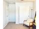 Bright bedroom featuring a plush chair, closet, and a crisp white door at 19221 E 65Th Ave, Denver, CO 80249