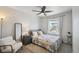 Cozy bedroom featuring a neutral color scheme, plush carpet, and a comfortable armchair at 19221 E 65Th Ave, Denver, CO 80249