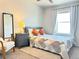 Cozy bedroom with a queen-sized bed, a soft rug, and bright natural light from the window at 19221 E 65Th Ave, Denver, CO 80249