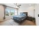Bright bedroom featuring large windows, ceiling fan, and comfortable bed with stylish bedding at 19221 E 65Th Ave, Denver, CO 80249