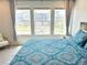 Bright bedroom with three large windows offering neighborhood views and a comfortable chair in the corner at 19221 E 65Th Ave, Denver, CO 80249