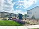 View of the community entrance sign with lush landscaping and well-maintained townhomes at 19221 E 65Th Ave, Denver, CO 80249