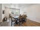 Open-concept space with a dining area adjacent to a living room filled with natural light and modern decor at 19221 E 65Th Ave, Denver, CO 80249