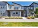 Modern townhome showcasing a contemporary architectural style, neat landscaping, and a welcoming walkway at 19221 E 65Th Ave, Denver, CO 80249