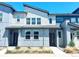 Modern two-story townhome with sleek architectural details and beautiful gray and white color scheme at 19221 E 65Th Ave, Denver, CO 80249