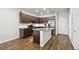 Spacious kitchen featuring dark wood cabinetry, granite countertops, a kitchen island, and stainless steel appliances at 19221 E 65Th Ave, Denver, CO 80249