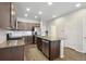Well-lit kitchen featuring granite countertops, stainless steel appliances, a central island, and stylish wood flooring at 19221 E 65Th Ave, Denver, CO 80249
