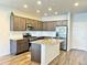 Stylish kitchen with granite countertops, stainless steel appliances, and dark wood cabinetry at 19221 E 65Th Ave, Denver, CO 80249