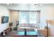 Inviting living area with large windows, plush sofa, and dining table, creating a welcoming space at 19221 E 65Th Ave, Denver, CO 80249