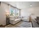 Inviting living room with a large sectional sofa, striped rug, and bright windows for natural light at 19221 E 65Th Ave, Denver, CO 80249