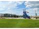 View of neighborhood playground with modern equipment and open green space at 19221 E 65Th Ave, Denver, CO 80249