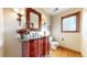 Charming powder room with decorative vanity, ornate mirror, and unique lighting fixtures at 6414 E Stanford Ave, Cherry Hills Village, CO 80111