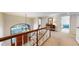 Sunlit upstairs hallway featuring a view of the home's lush yard at 6414 E Stanford Ave, Cherry Hills Village, CO 80111