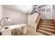 Finished basement area featuring a desk, adjacent staircase and chandelier at 6414 E Stanford Ave, Cherry Hills Village, CO 80111
