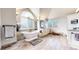 An airy bathroom featuring a soaking tub, vaulted ceilings, and wood-look tile flooring at 6414 E Stanford Ave, Cherry Hills Village, CO 80111