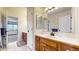 Bathroom with wooden cabinets, white sink and tile flooring at 6414 E Stanford Ave, Cherry Hills Village, CO 80111