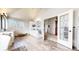 An airy bathroom with an exterior door, dual vanities, vaulted ceilings, and wood-look tile flooring at 6414 E Stanford Ave, Cherry Hills Village, CO 80111