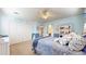 Bright bedroom with white trim and wainscotting features a ceiling fan and plenty of closet space at 6414 E Stanford Ave, Cherry Hills Village, CO 80111