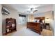 A primary bedroom with a ceiling fan, hardwood floors, and a full bookshelf for display at 6414 E Stanford Ave, Cherry Hills Village, CO 80111