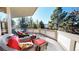 Relaxing deck with wicker furniture and views of the surrounding trees at 6414 E Stanford Ave, Cherry Hills Village, CO 80111