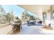 Outdoor deck featuring grill, table and chairs and expansive view of the surrounding greenery at 6414 E Stanford Ave, Cherry Hills Village, CO 80111