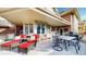 Spacious deck area with wicker chairs, table, and grill, perfect for outdoor entertaining at 6414 E Stanford Ave, Cherry Hills Village, CO 80111