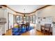Bright dining area features a bay window, wood trim and flooring, as well as a modern blue rug and built in desk at 6414 E Stanford Ave, Cherry Hills Village, CO 80111