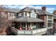 Exterior of house featuring private deck and lush landscaping, and brick facade at 6414 E Stanford Ave, Cherry Hills Village, CO 80111