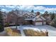 Beautiful brick home showcasing a well-manicured lawn, mature trees, and a spacious driveway at 6414 E Stanford Ave, Cherry Hills Village, CO 80111