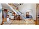 Grand foyer featuring elegant tile flooring, a curved staircase with white railings and hardwood steps at 6414 E Stanford Ave, Cherry Hills Village, CO 80111