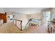 Hallway featuring a staircase with a railing, chandelier, and a large window overlooking the front yard at 6414 E Stanford Ave, Cherry Hills Village, CO 80111