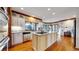 Bright kitchen featuring a central island with granite countertops, white cabinetry, and wood trim at 6414 E Stanford Ave, Cherry Hills Village, CO 80111