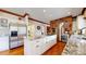 Gourmet kitchen featuring a center island, stainless steel appliances, and a brick arch detail at 6414 E Stanford Ave, Cherry Hills Village, CO 80111